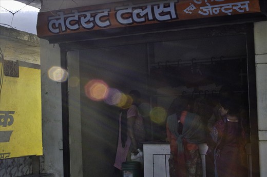 In small tailors' shop girls were collected and sun beams were hitting them