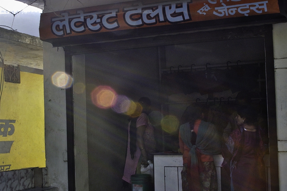 In small tailors' shop girls were collected and sun beams were hitting them