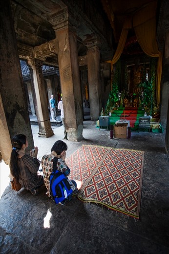 Residents pray to one of the many gods in Angkor Wat.

Angkor Wat, Cambodia.