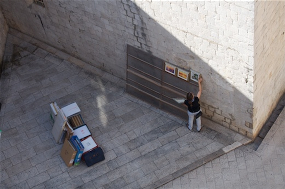 Shop owner setting up her stand before tourist flood the city