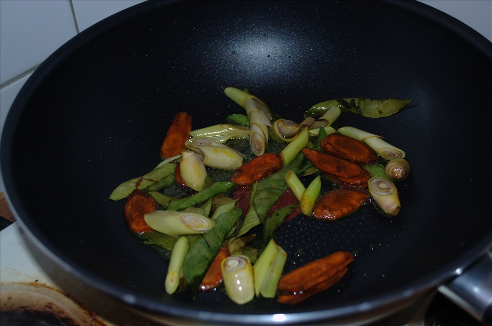 Frying galangal, lemongrass and kaffir lime leaves together
