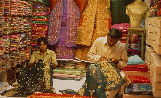 Masters of embroidery in an open-air bazaar in Karachi. Here it is a man privilege to decorate the woman's attire.
