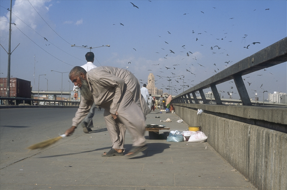 Native Jetty Bridge in Karachi is a crowded place in the bustling city. It is where you can wash your sins, ask Got for forgiveness or find your internal peace simply by making an offering to the creatures of nature – birds and fish. A merchant selling bites of food sweeps his makeshift stall.