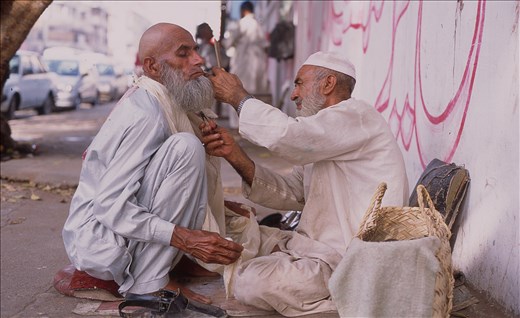 In Karachi the entrepreneur spirit is high. Whenever there is a demand for something, there is someone to do it. Some skills like this improvised barber shop are performed straight on the street.