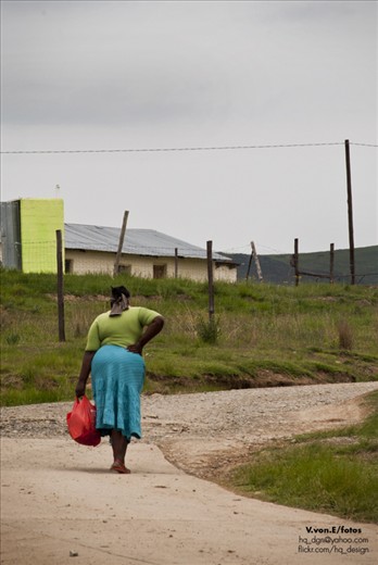 A local lady. I like to imagine that she is going home, to meet with her children after a long day. 