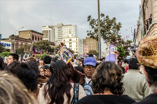 A man sells posters of Señor de Los Milagros.  