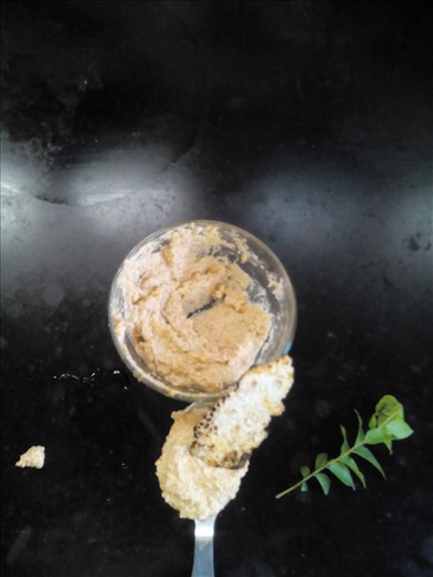 Akki roti dipped in a spoonful of Sesame chutney (Ellupajji)