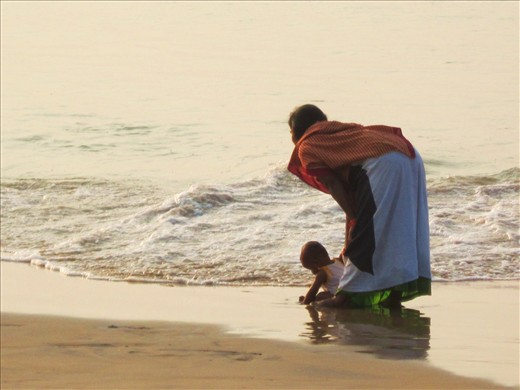 Woman on Watch: Baby and the Bay of Bengal, at Puri Sea Beach, Orissa, India.