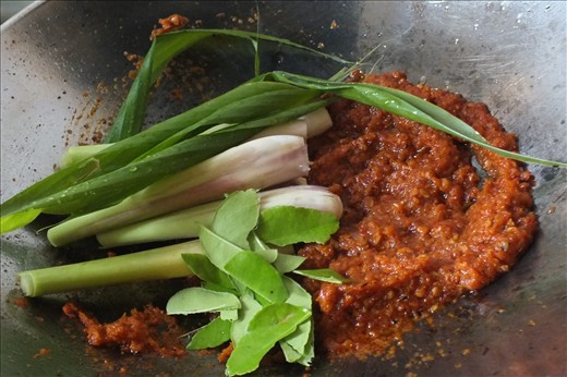 Aromatic herbs are added to the cooked sambal.