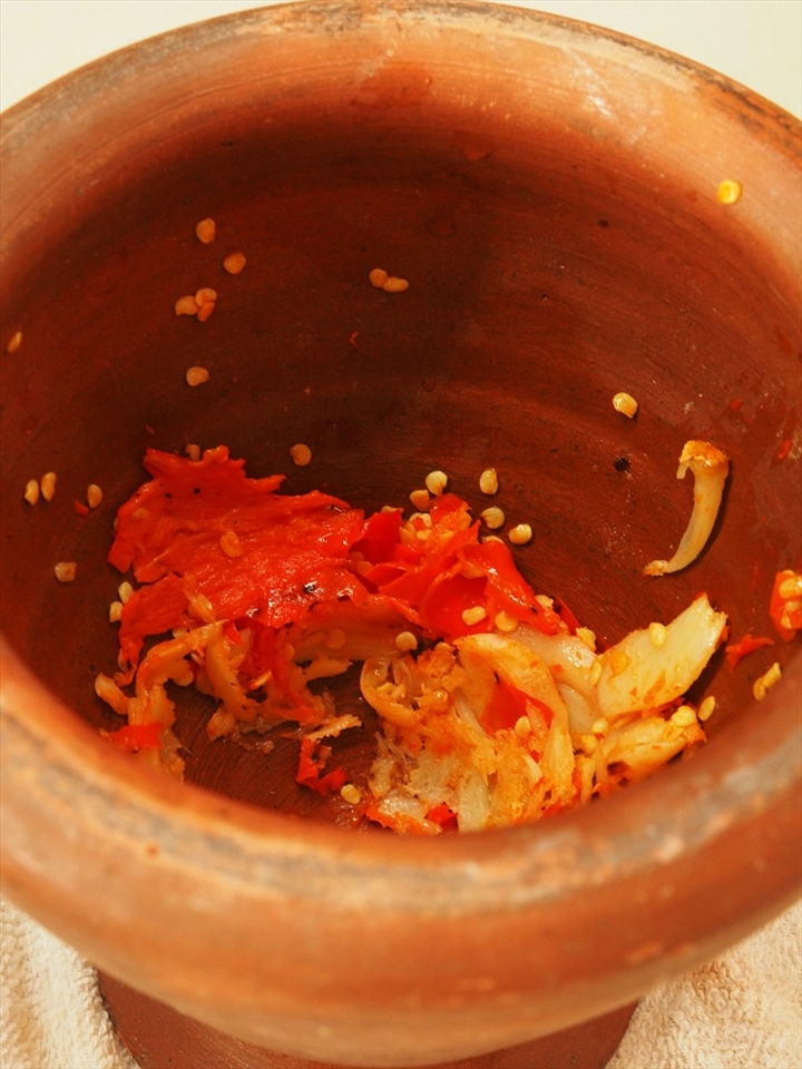 Chilies, garlics and red onions grinded in the mortar.