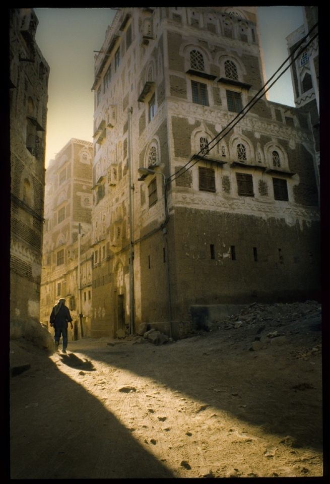 A villager enters a tiny shaft of sun that cuts through the tiny streets of the old Medina. This image could be seen as an homage to the surrealist painter De Chirico and his solitary figures set in strange and perhaps foreboding urban landscapes.