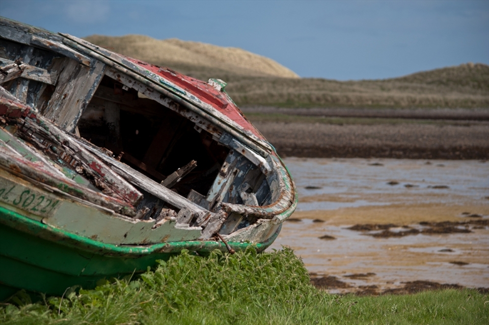 An old forgotten boat, just lying there at the northwestern shore of Ireland, Donegal. It is an unreal place, far off the beaten tourist tracks, altered by clouds, sun and rain every minute. Boats have a very romantic aspect, merging very well with the landscape.