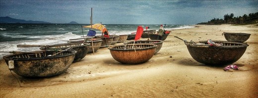 Round boats on the beach at An Bang