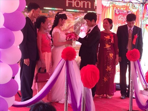 Our first Vietnamese wedding. Bride and groom exchanging rings. 