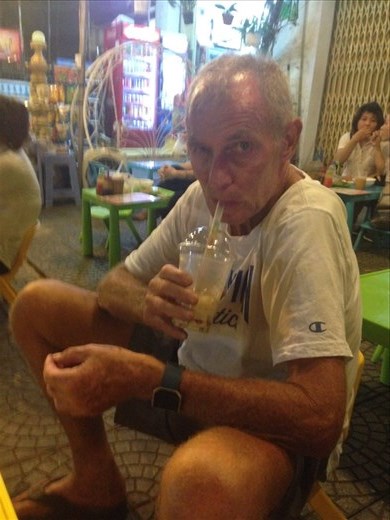 Kevin drinking Peach milk with coloured jellies sitting on the real small seats. 