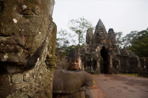 Passing the guardian statues at the entrance to the Angkor complex of temples.