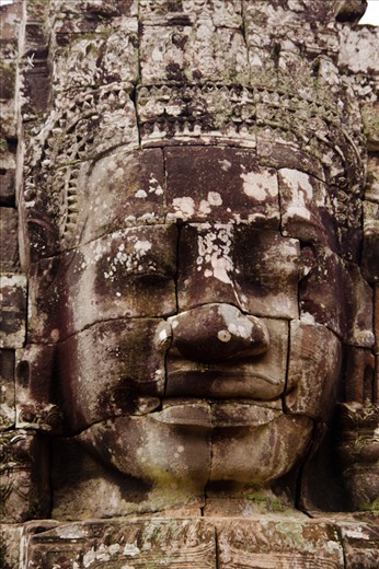 One of the many faces of the Bayon Temple, situated within the Angkor Temples.