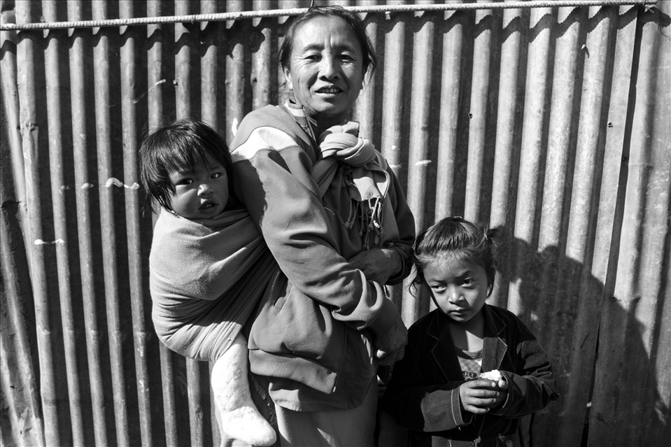 While waiting for a bus in Kohima, India this family of three appears in all their glory.