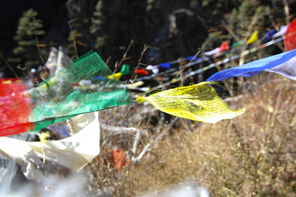 Nepal Pray Flags feature constantly throughout the Himalayas. Sherpas tie the flags to bridges and shrines that speckle the landscape as prayers to the five elements (sky, air, earth, water and fire) for a safe journey