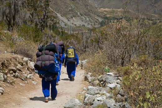 The Chaskis (porters) carry provisions and tents for trekkers on the Inca Trail to the lost city of Machu Picchu in the Peruvian Andes. The small stature of these men belies their strength – they carry loads of over 30kg and climb nimbly up and down the mountain sides at high altitude. They are the descendants of highly trained runners (also called Chaskis) who used the extensive network of roads built by the Inca to deliver messages throughout the vast empire