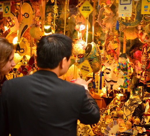 A tourist picks out a Guy Fawkes mask with his partner. Every year Venice celebrates the legendary Carnivale festival, where the masqueraders take to the streets in their lavish costumes. Each outfit is topped off with a stunning mask. Some sequinned and gentile and others downright haunting. Choosing the right one is crucial to the role you wish to portray. 