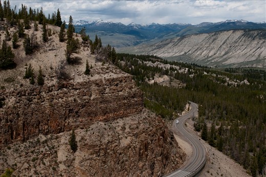 The grand loop road winds up, further into the mountains in Yellowstone National Park. 
