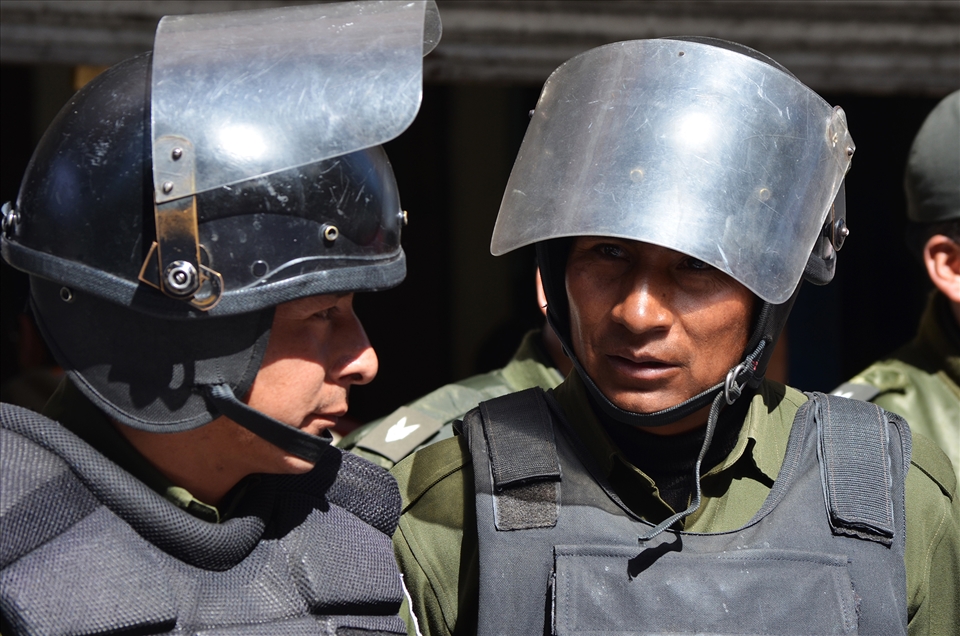 Two police officers take a moment to observe their surroundings.