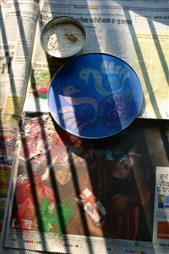 Like Christmas in the United States, Diwali has become a highly capitalized on holiday. In this photo I like the juxtaposition of the shadows from the rising sun onto a newspaper selling “Hot Diwali Deals” as we created the Rangoli. In my mind this was a metaphor of the old traditions winning out as my mom used the newspaper to pick up the excess sand she spilled, paying no attention to what it was selling.  