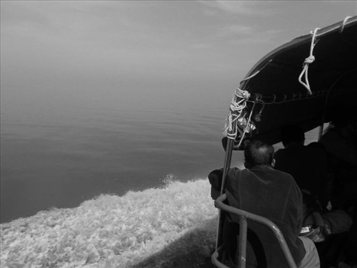 I traveled to a town called Ketapang in Borneo,an oldman was enjoying the sea.