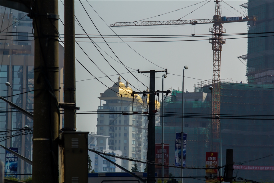 Golden top lost in the grey urban lines of Shanghai.