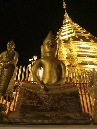The Enlightened One illuminated at night (Wat Phrathat Doi Suthep, Chiang Mai).