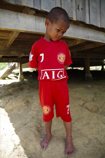 Looking wise beyond his years, this child awaits the arrival of our Xmas party.