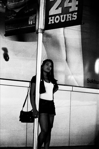 I've had worse jobs.
Women of all ages and cultures use their body to survive, throughout my trip to Thailand, I found a large amount of women struggling to live, young and old. This young lady caught my eye as I was driving past, the positioning of her body under a sign for the convenience store fascinated me. It made think about the lives of all prostitutes and escorts.  