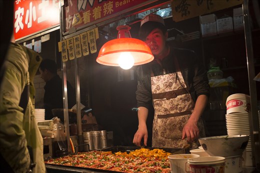 Young Chinese Muslims often spend their evenings working in their family's small business, making and serving an endless supply of treats. Fried tofu and vegetables are some of the favourites.   