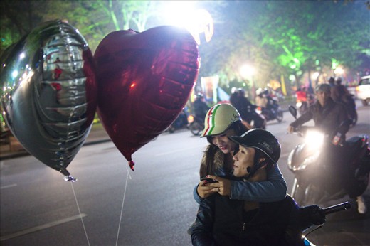 A young couple hangs out on the street of Hanoi on Valentine's day. Vietnam 2013