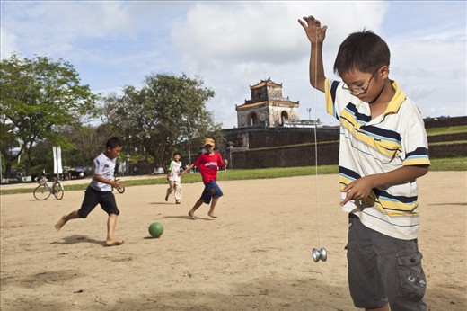 Kids plays beside the ancient royal palace in Hue, Vietnam 2013