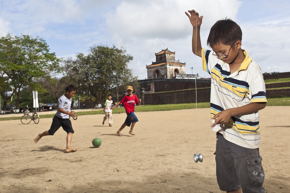 Kids plays beside the ancient royal palace in Hue, Vietnam 2013
