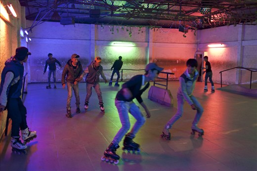Young men Play roller-skating at a night club, Da lat, Vietnam 2013