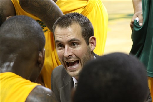 Coach Jordan Dreiling gives senior Maurice O'field the game plan during a time call