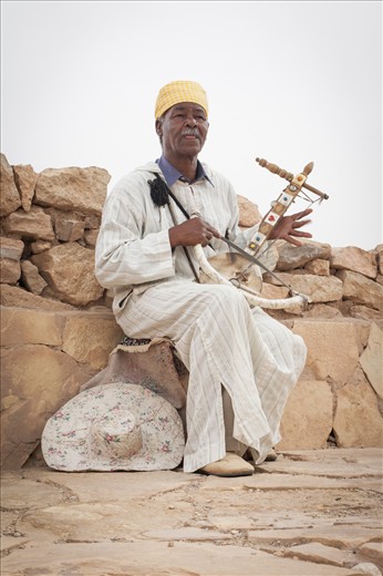 Every day this street musician fills the heavy afternoon air with the lightest and chirpiest melody, playing his one string Berber lute. He was so immersed in the beauty of his tune that he forgot to lay down his hat for tips. His heart sang through the lonely string.