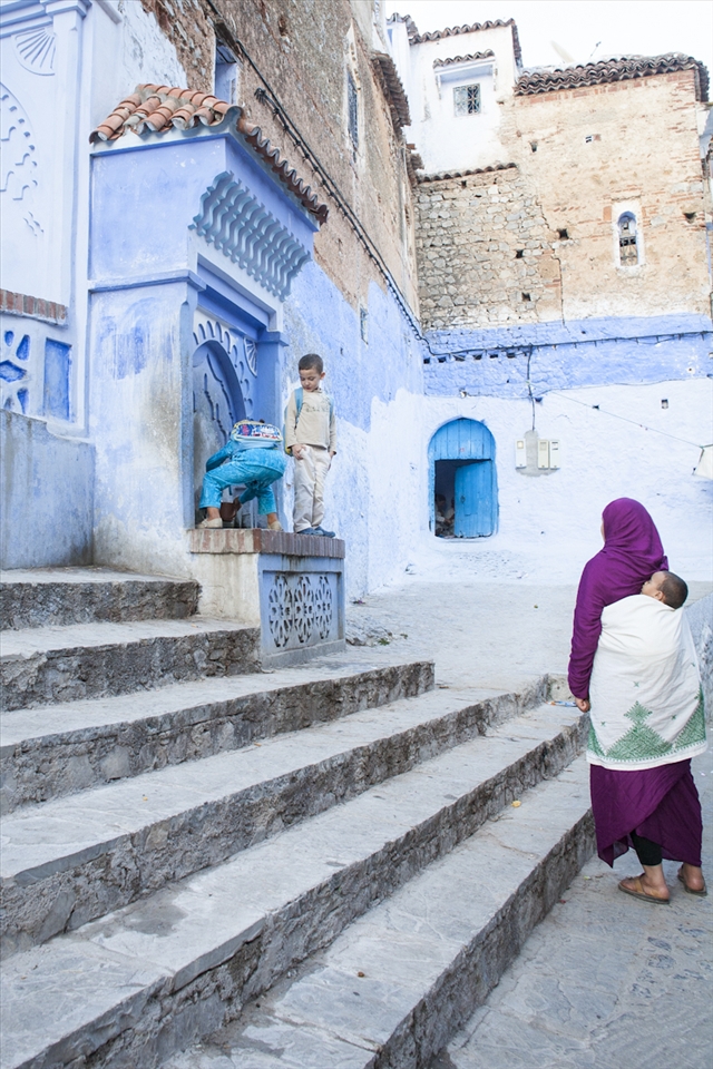 This mother has to carry the heavy load of raising her children through the stairs of life. She is a lone hero in her motherly role but her children fill her life with comfort and beauty while her husband sweats in the heat to feed the family. 