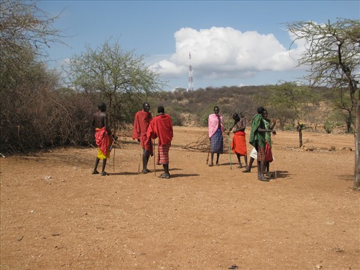 CAUGHT - Arriving to meet the Samburu tribe in the northern part of Kenya, the tribesmen hid their mobile phones in their 'shukkas' (skirt-like clothing). They appear embarrassed, but it's clear from the mobile phone tower in the background that even technology has made its way to the outback of Kenya.