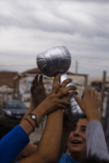 The winners of a football game celebrating with their  prize. 