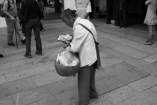 Meet Wu Ming. She weaves reeds and flowers together to create bracelets in which she sells for ¥10 (AUD$1.80). This is her only form of income however when I spoke to her she stated that she was content with her life and the only thing she would ask for was a bigger basket. 