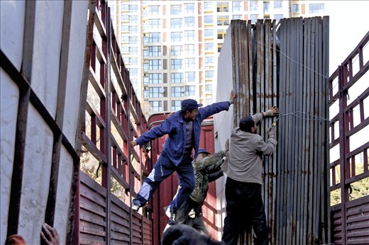 Chinese construction workers use few machines. Putting the metal slabs in the truck required eight men’s strength. Their hard labor is creating a legacy for the future visitors of Yugu’an Temple.