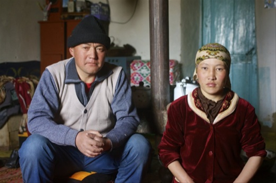A Kyrgyz couple take shelter inside from the cold, at Madian, Pamir.