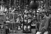 This salesman closely watches the tourists to avoid any theft of the innumerable pieces of traditional Omani ornaments and souvenirs.: by zahir, Views[2425]