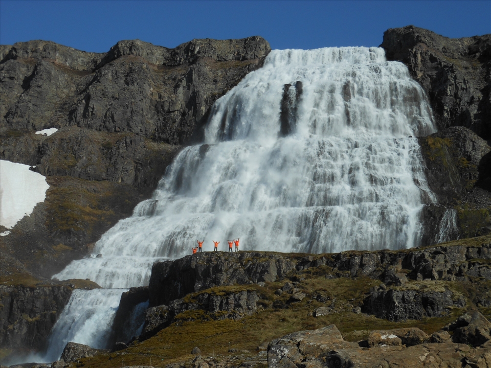 The small group of the volunteers in front of the waterfall Dynjandi.