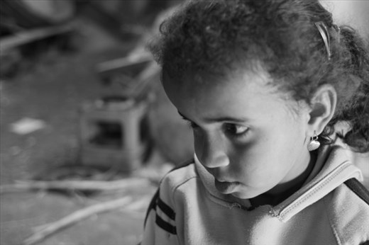 This beautiful girl was sad that her little brother was upset with her.