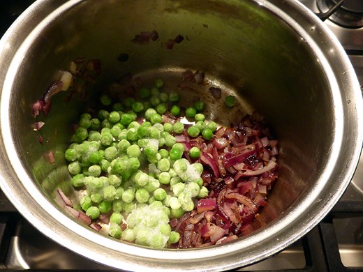 The softened onions, fried spices and frozen peas.